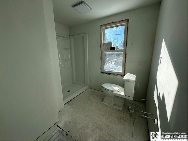 bathroom featuring a shower and toilet