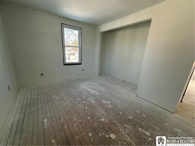 unfurnished bedroom with light hardwood / wood-style floors and a closet