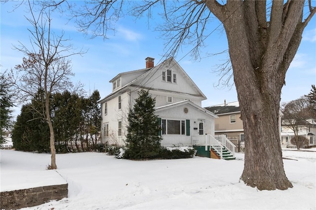 view of snow covered back of property