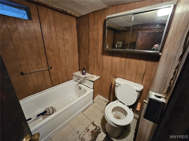 bathroom featuring toilet, wooden walls, and a bath