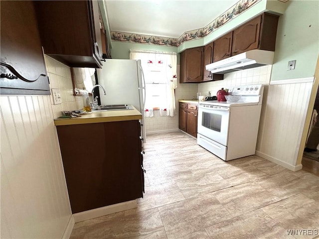 kitchen featuring decorative backsplash, white electric range, sink, and dark brown cabinets