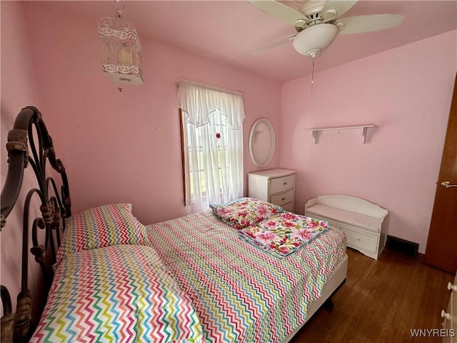 bedroom with ceiling fan and dark hardwood / wood-style flooring