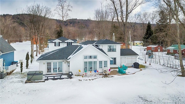 view of snow covered back of property