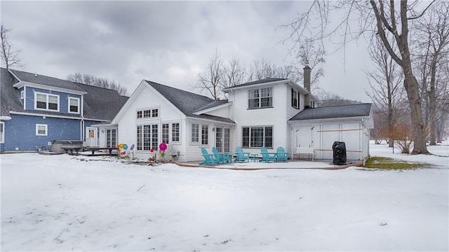 snow covered property featuring a garage