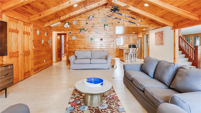 living room featuring ceiling fan, wood walls, lofted ceiling with beams, and wooden ceiling