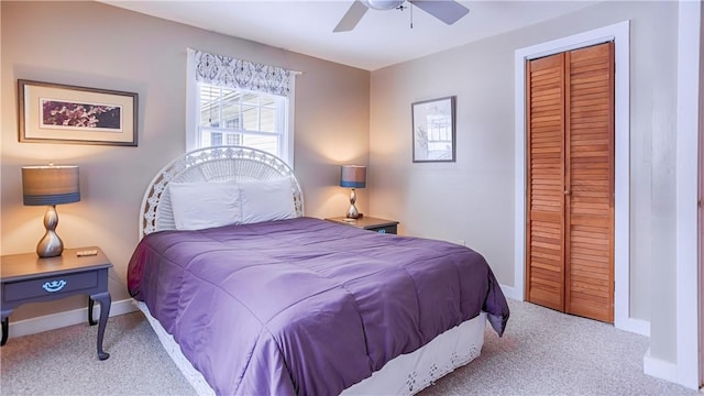 carpeted bedroom with ceiling fan and a closet