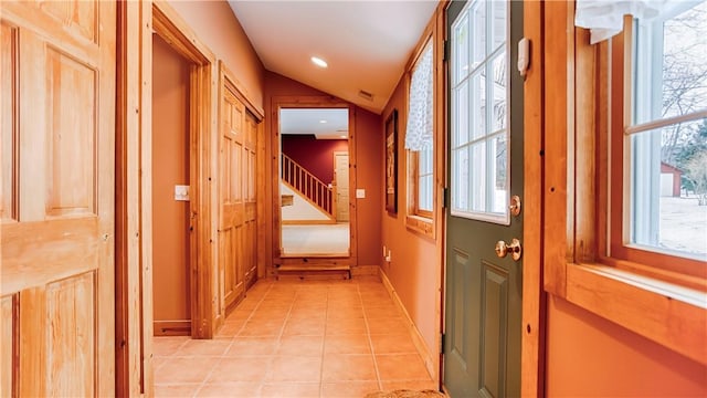 entryway featuring lofted ceiling and light tile patterned floors