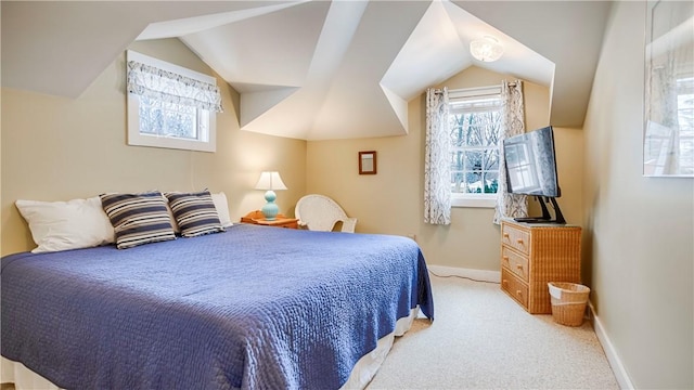 carpeted bedroom with vaulted ceiling