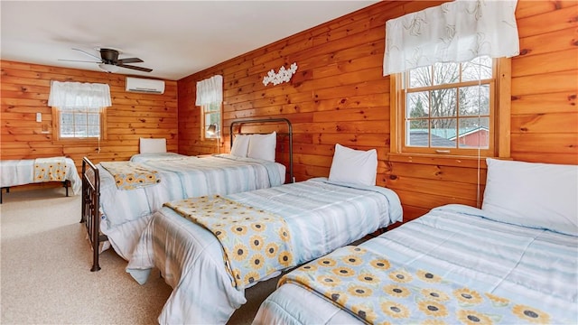 carpeted bedroom featuring a wall unit AC, ceiling fan, and wood walls