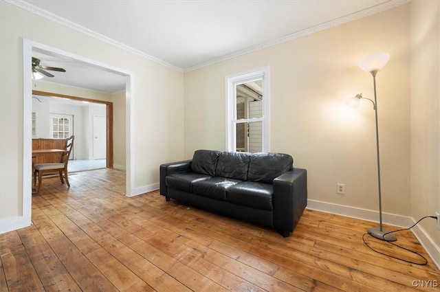 sitting room with ornamental molding, ceiling fan, and light hardwood / wood-style floors