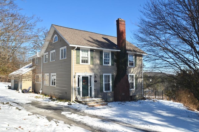 colonial home featuring a chimney