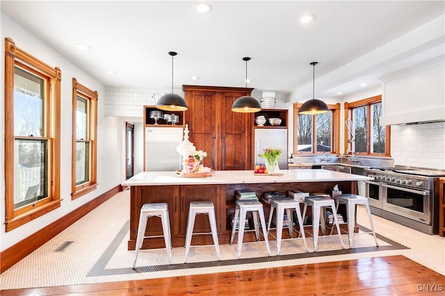 kitchen featuring hanging light fixtures, a center island, and appliances with stainless steel finishes