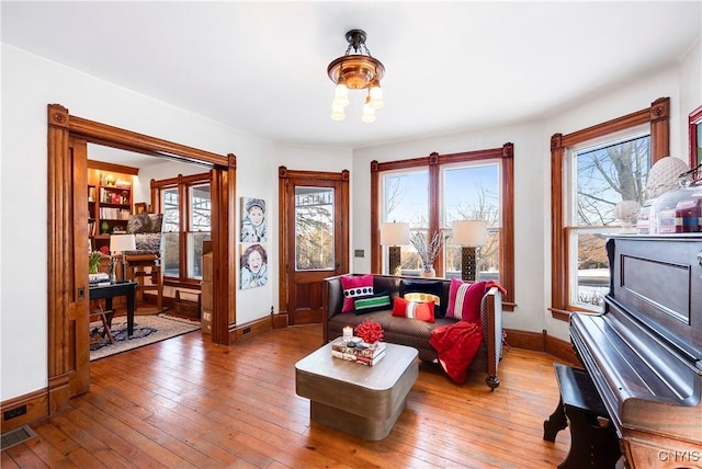 living area with plenty of natural light and hardwood / wood-style floors