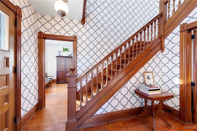 stairs with hardwood / wood-style flooring