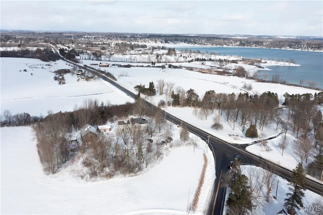 snowy aerial view with a water view