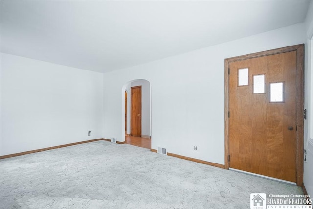 unfurnished room featuring light carpet