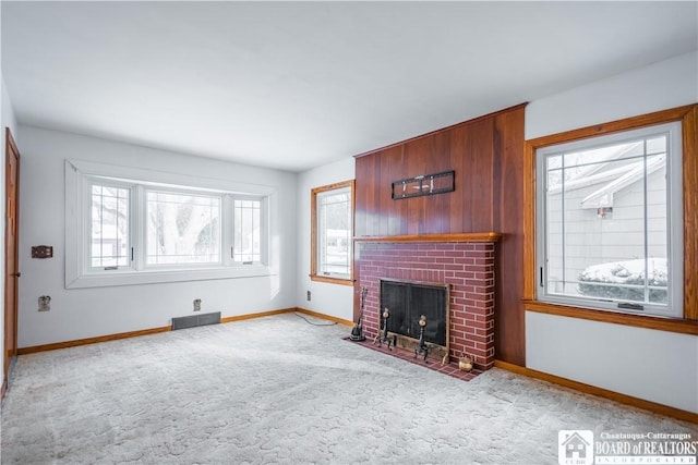 unfurnished living room featuring light colored carpet and a fireplace