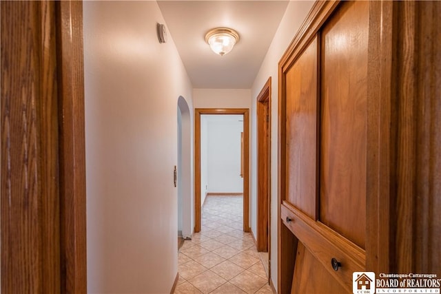 hall featuring light tile patterned flooring