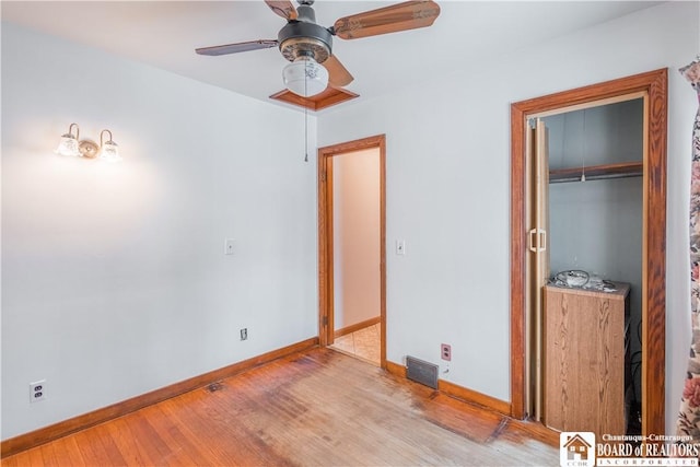 unfurnished bedroom featuring a closet, ceiling fan, and light hardwood / wood-style flooring