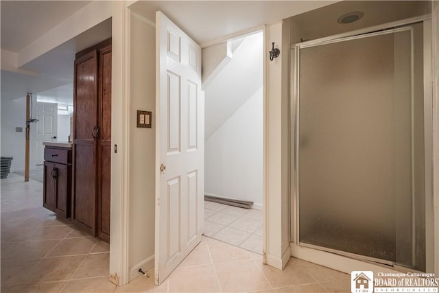 hall featuring light tile patterned flooring