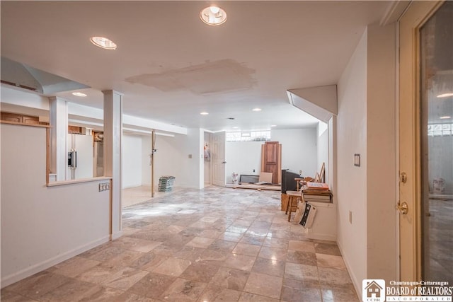 basement with white fridge with ice dispenser