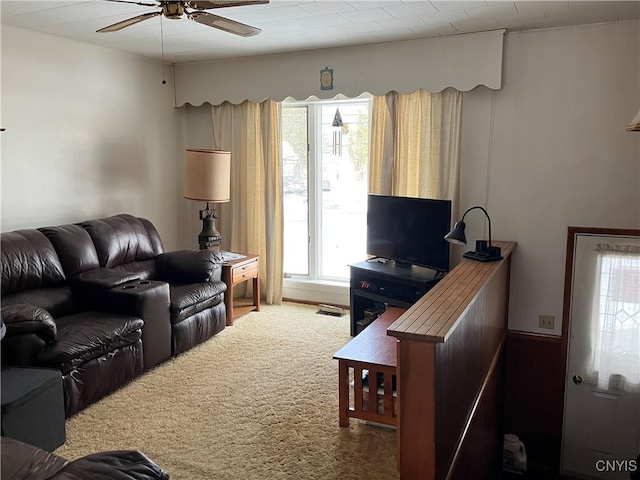 living room with ceiling fan and carpet flooring