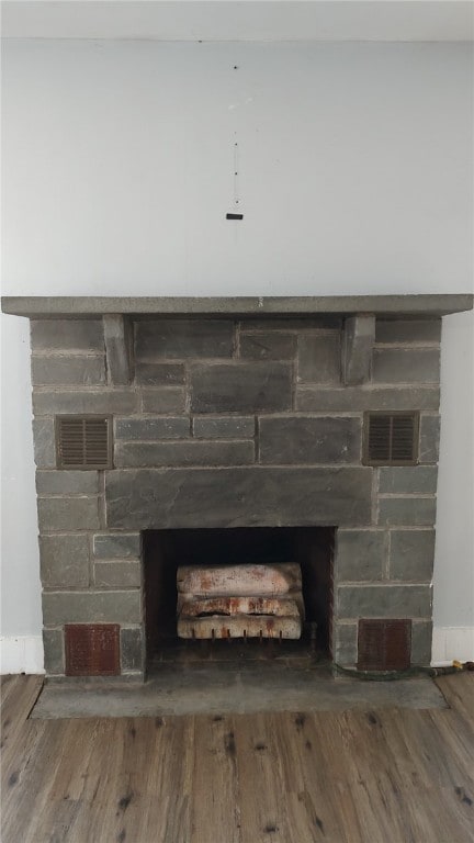 interior details featuring hardwood / wood-style flooring and a fireplace