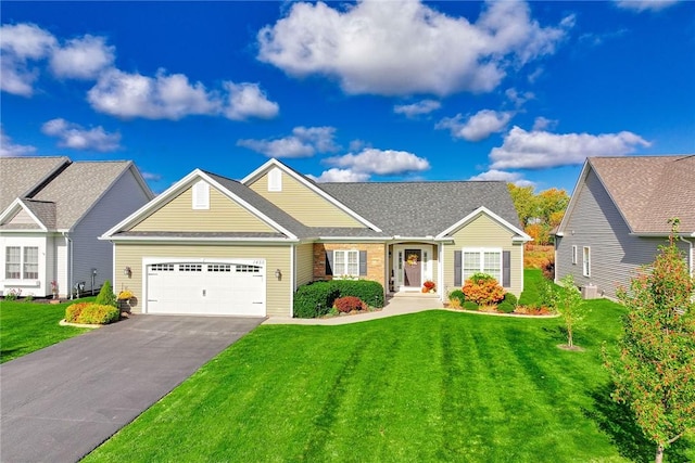 view of front of house with a garage and a front yard