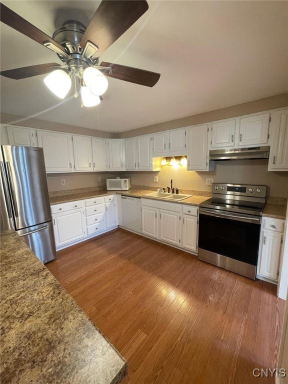 kitchen with appliances with stainless steel finishes, sink, light hardwood / wood-style floors, and white cabinets