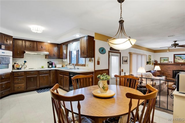 dining room with ceiling fan and sink