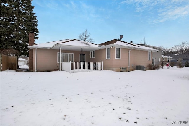 snow covered property with cooling unit