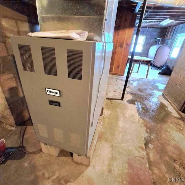 utility room featuring heating unit