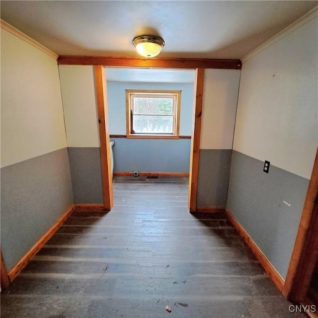 hallway featuring ornamental molding and dark hardwood / wood-style flooring