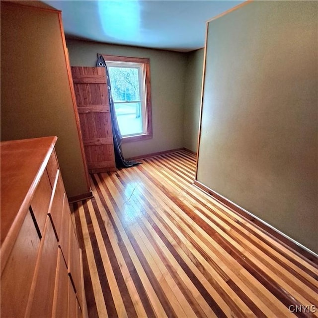 empty room with light hardwood / wood-style floors