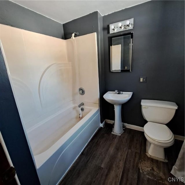 full bathroom with hardwood / wood-style floors,  shower combination, sink, and toilet