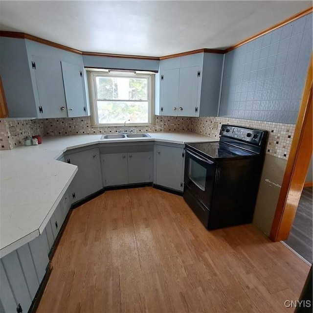 kitchen featuring sink, light hardwood / wood-style flooring, ornamental molding, black range with electric cooktop, and decorative backsplash