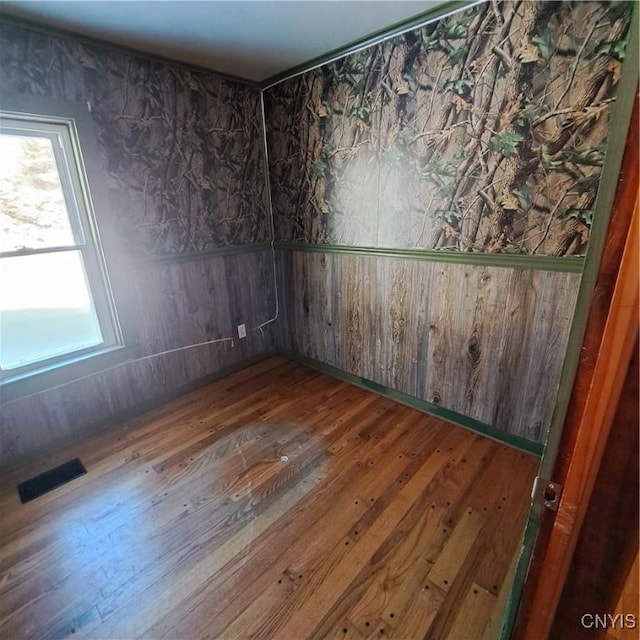 spare room featuring wood-type flooring