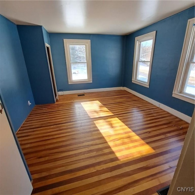 spare room with hardwood / wood-style flooring