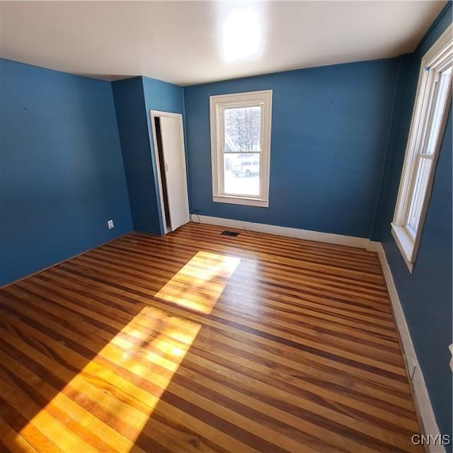 spare room with hardwood / wood-style flooring