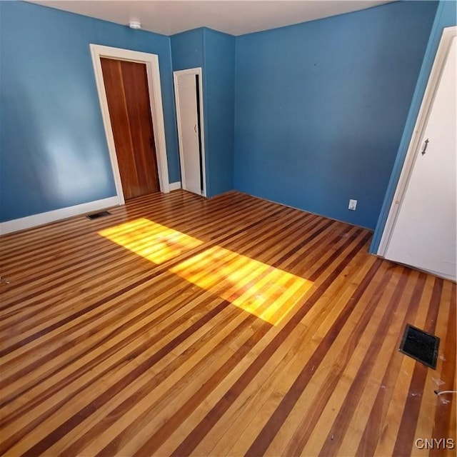 unfurnished bedroom with hardwood / wood-style floors