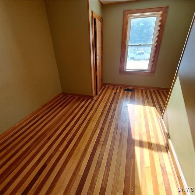 empty room with light hardwood / wood-style floors