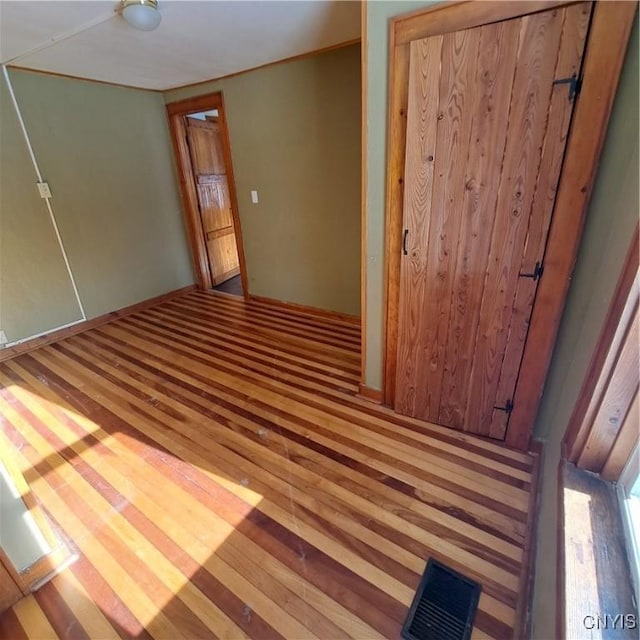 unfurnished room featuring hardwood / wood-style flooring