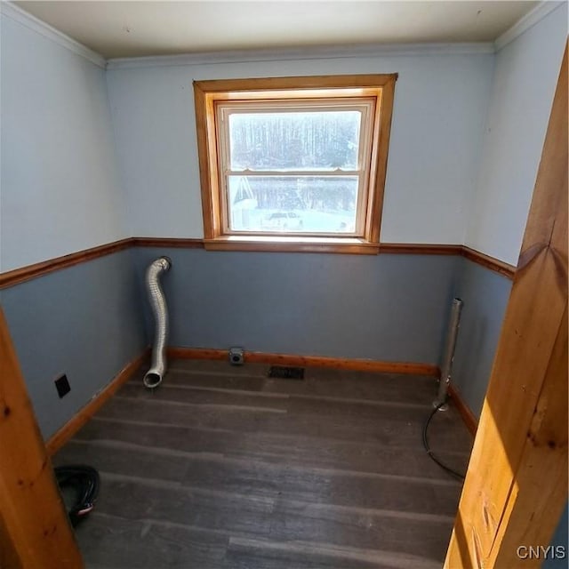 laundry area featuring crown molding and hardwood / wood-style floors