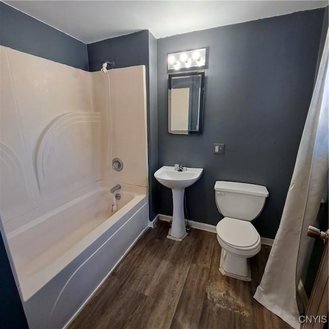 full bathroom with hardwood / wood-style flooring, shower / tub combination, toilet, and sink