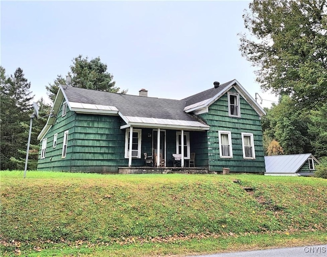 view of front of property featuring covered porch and a front yard