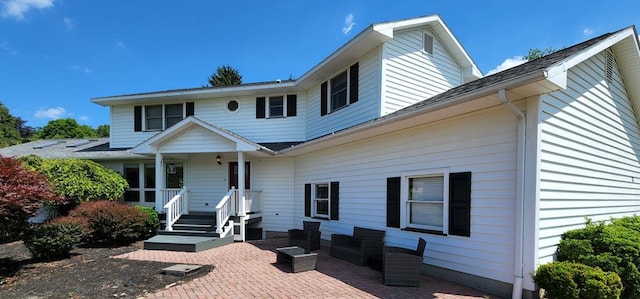 rear view of property featuring a patio