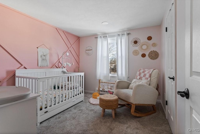 carpeted bedroom with a nursery area