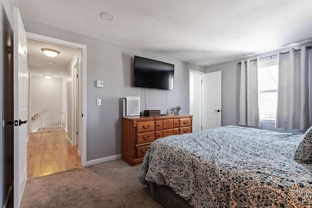 bedroom featuring light carpet