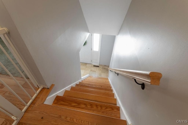 staircase with lofted ceiling