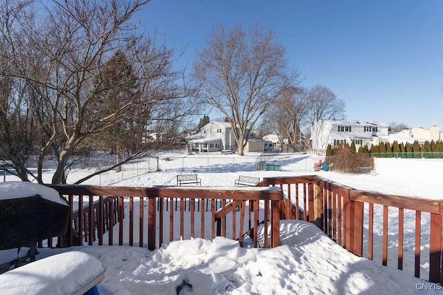 snow covered deck with a grill